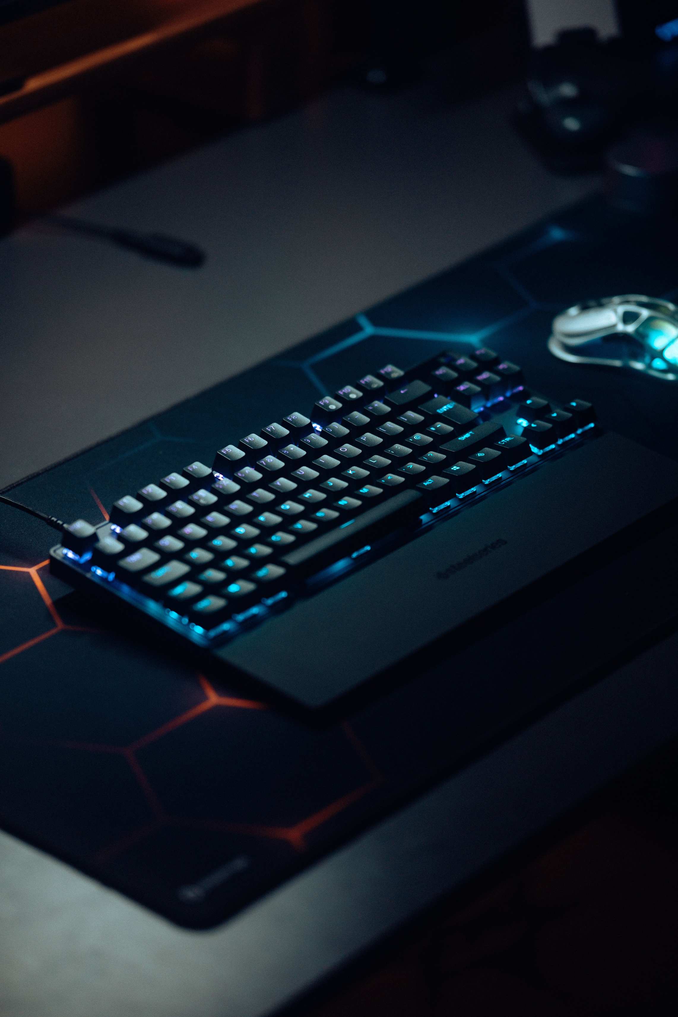 Developer mechanical keyboard and peripherals on a desk with RGB lighting